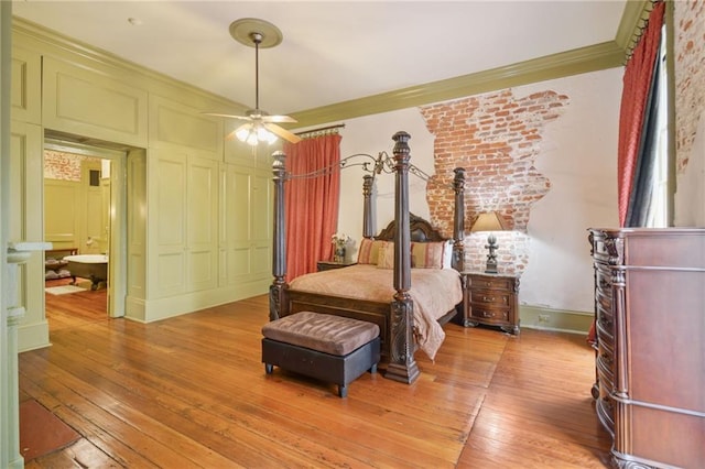 818 Lafayette St Unit 818, New Orleans, LA 70113 - bedroom with ornamental molding, a decorative wall, light wood-type flooring, a closet, and connected bathroom