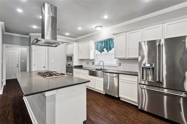 44128 Halter Ln, Hammond, LA 70403 - kitchen featuring appliances with stainless steel finishes, dark countertops, dark wood-type flooring, island exhaust hood, and crown molding