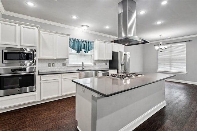 44128 Halter Ln, Hammond, LA 70403 - kitchen featuring appliances with stainless steel finishes, island exhaust hood, crown molding, dark wood-style floors, and white cabinetry