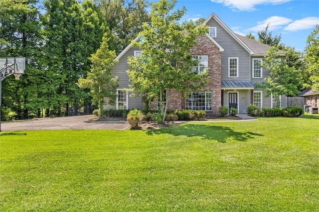 647 Highland Oaks Dr, Baton Rouge, LA 70810 - view of front of property with a front yard, brick siding, and a standing seam roof