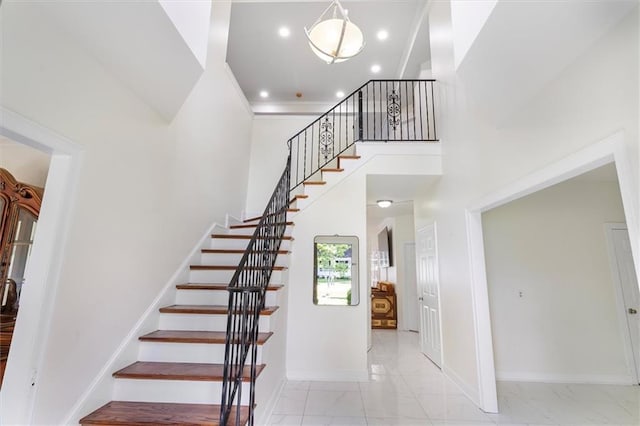647 Highland Oaks Dr, Baton Rouge, LA 70810 - stairway featuring marble look tiles, recessed lighting, and a high ceiling
