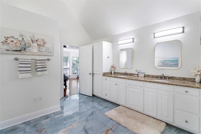 647 Highland Oaks Dr, Baton Rouge, LA 70810 - bathroom with vaulted ceiling, double vanity, and marble finish floors