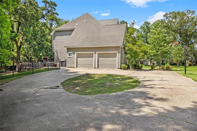 647 Highland Oaks Dr, Baton Rouge, LA 70810 - view of side of home with asphalt driveway, a garage, and roof with shingles