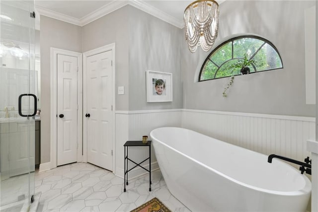 103 Century Oaks Ln, Mandeville, LA 70471 - bathroom featuring a shower stall, a freestanding bath, a chandelier, a wainscoted wall, and crown molding