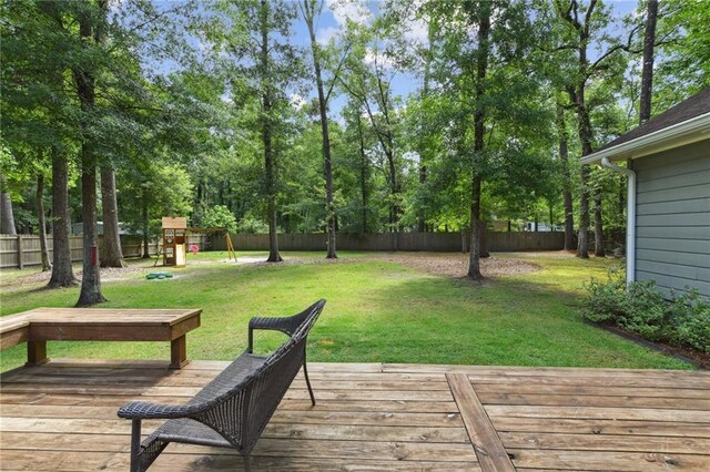 103 Century Oaks Ln, Mandeville, LA 70471 - wooden deck featuring a playground and a fenced backyard