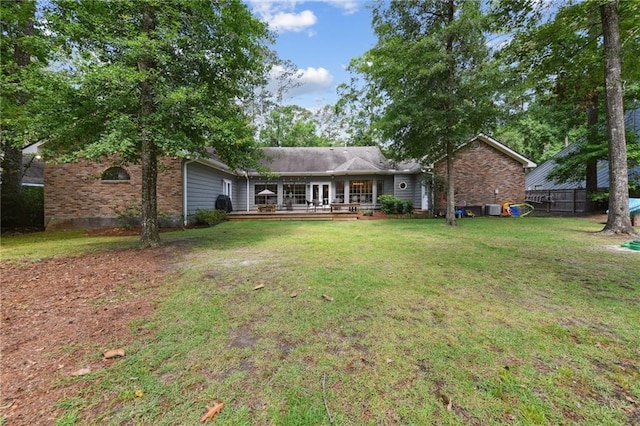 103 Century Oaks Ln, Mandeville, LA 70471 - rear view of house featuring a deck, a lawn, and brick siding
