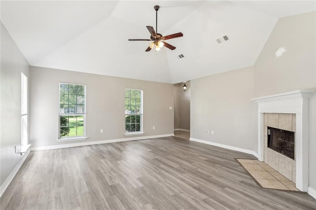 3298 Rama St, Slidell, LA 70458 - unfurnished living room featuring a ceiling fan, light wood-style flooring, high vaulted ceiling, and a tile fireplace