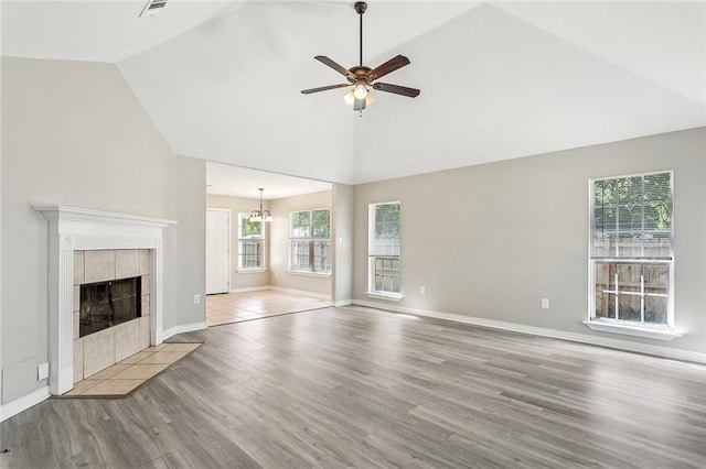 3298 Rama St, Slidell, LA 70458 - unfurnished living room featuring ceiling fan, wood finished floors, a chandelier, a fireplace, and high vaulted ceiling