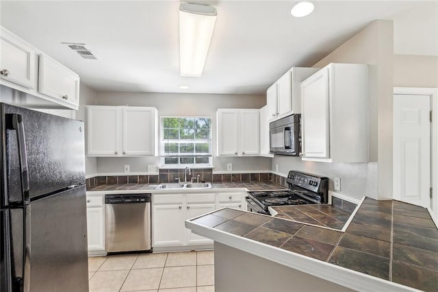 3298 Rama St, Slidell, LA 70458 - kitchen featuring black appliances, white cabinets, a peninsula, recessed lighting, and light tile patterned flooring