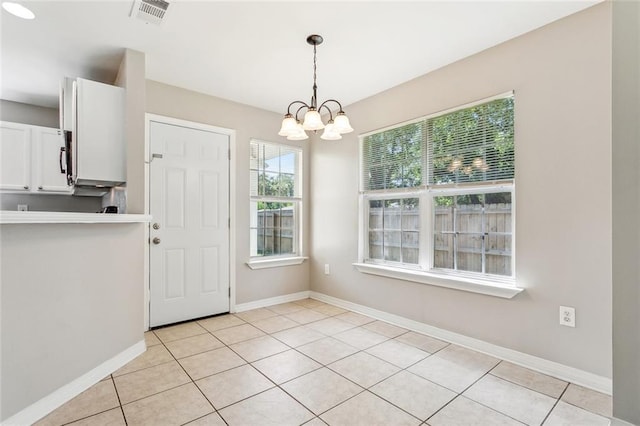 3298 Rama St, Slidell, LA 70458 - unfurnished dining area featuring a chandelier and light tile patterned floors