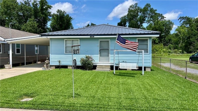 217 Evangeline Rd, Montz, LA 70068 - view of front facade featuring driveway, an attached carport, a metal roof, and entry steps