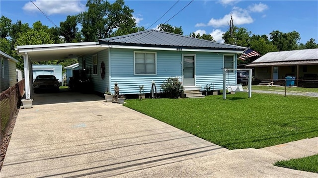 217 Evangeline Rd, Montz, LA 70068 - view of front facade with entry steps, driveway, a carport, and a metal roof