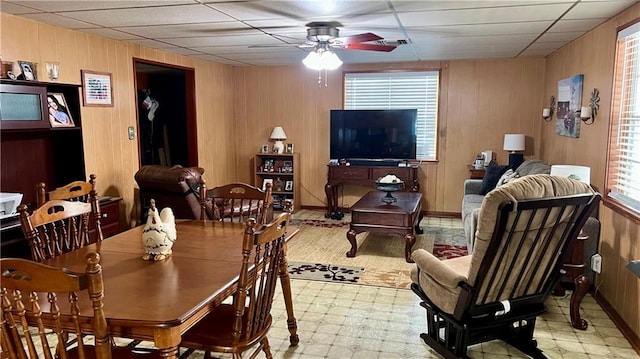 217 Evangeline Rd, Montz, LA 70068 - dining space featuring ceiling fan, healthy amount of natural light, tile patterned floors, and wooden walls