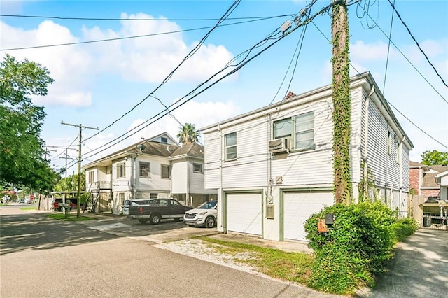 400 Aris Ave, Metairie, LA 70005 - view of side of home featuring a garage, a residential view, and cooling unit