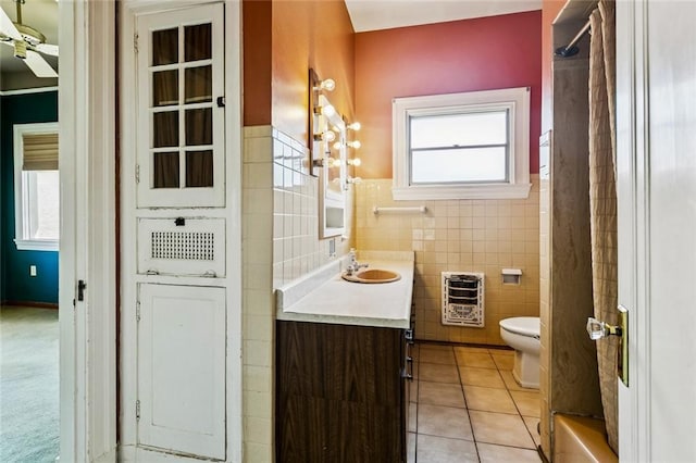 400 Aris Ave, Metairie, LA 70005 - full bathroom featuring heating unit, tile walls, tile patterned flooring, vanity, and a shower