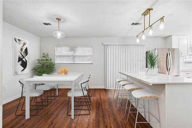 802 Claiborne Dr, Jefferson, LA 70121 - dining room featuring dark wood-style flooring and healthy amount of natural light