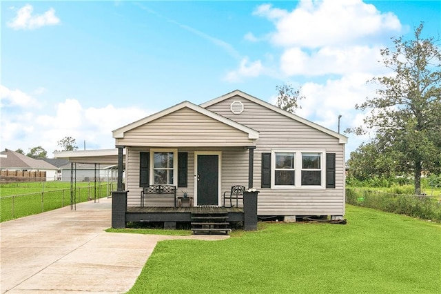 413 Fir St, La Place, LA 70068 - view of front of house with a porch, driveway, and a carport