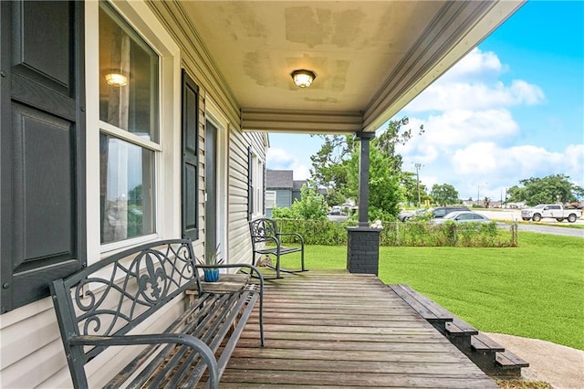 413 Fir St, La Place, LA 70068 - wooden porch featuring a lawn
