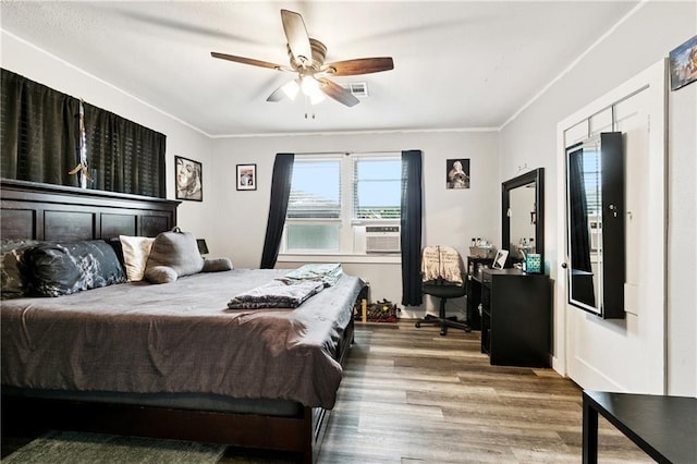 413 Fir St, La Place, LA 70068 - bedroom with wood finished floors, crown molding, cooling unit, and ceiling fan