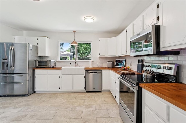 400 W Lake Catahoula Ct, Slidell, LA 70461 - kitchen featuring appliances with stainless steel finishes, wooden counters, tasteful backsplash, and white cabinetry