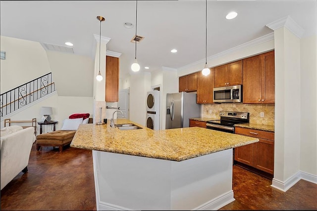 8000 Stonelake Village Ave Unit 406, Baton Rouge, LA 70820 - kitchen featuring stainless steel appliances, concrete flooring, estacked washer and dryer, brown cabinets, and recessed lighting