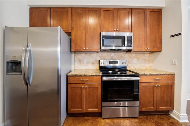 8000 Stonelake Village Ave Unit 406, Baton Rouge, LA 70820 - kitchen with appliances with stainless steel finishes, decorative backsplash, light stone counters, and brown cabinets