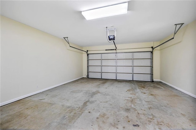 8000 Stonelake Village Ave Unit 406, Baton Rouge, LA 70820 - garage featuring baseboards and a garage door opener