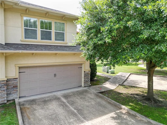 8000 Stonelake Village Ave Unit 406, Baton Rouge, LA 70820 - view of front of home with stone siding, stucco siding, and an attached garage