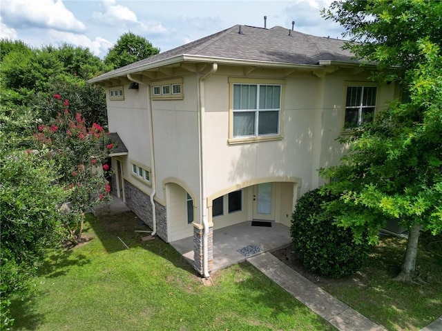 8000 Stonelake Village Ave Unit 406, Baton Rouge, LA 70820 - back of property with a patio area, stucco siding, a lawn, and a shingled roof