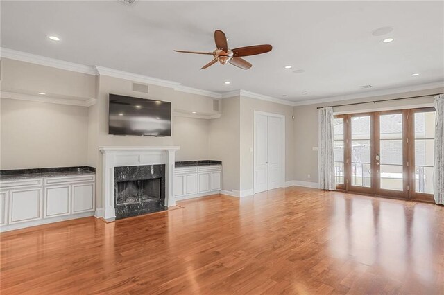 152 Portland St, New Orleans, LA 70124 - unfurnished living room featuring ceiling fan, a high end fireplace, recessed lighting, light wood finished floors, and ornamental molding