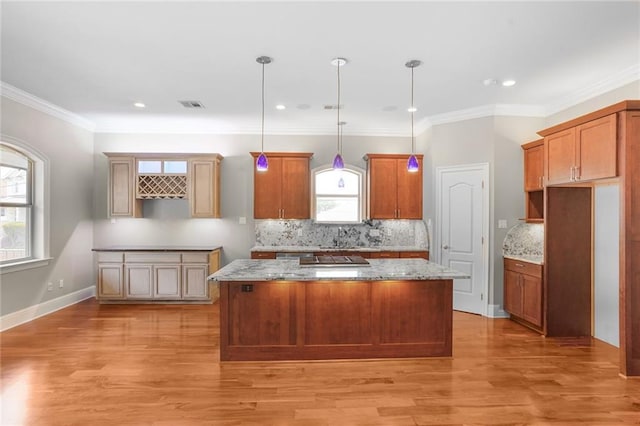 152 Portland St, New Orleans, LA 70124 - kitchen with a kitchen island, healthy amount of natural light, light wood-style floors, recessed lighting, and crown molding