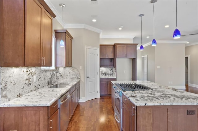 152 Portland St, New Orleans, LA 70124 - kitchen featuring appliances with stainless steel finishes, dark wood finished floors, a kitchen island, crown molding, and light stone countertops
