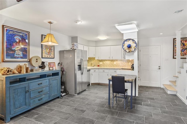 2305 Cleary Ave Unit 225, Metairie, LA 70001 - kitchen with stainless steel fridge with ice dispenser, white cabinetry, tasteful backsplash, decorative light fixtures, and light countertops