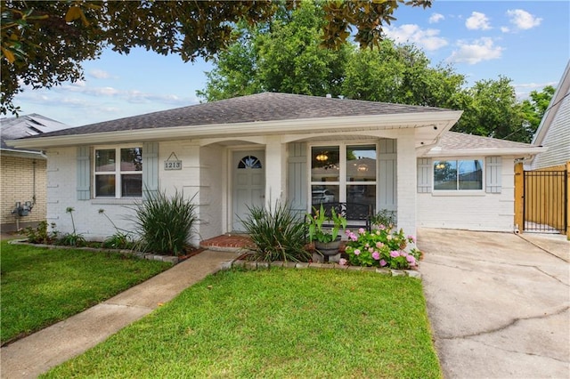 1213 Focis St, Metairie, LA 70005 - bungalow-style home featuring brick siding, roof with shingles, concrete driveway, and a porch