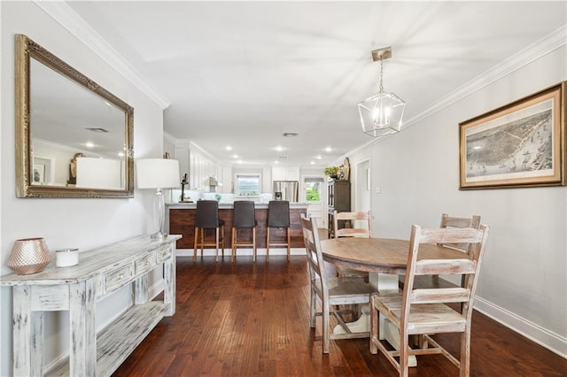 1213 Focis St, Metairie, LA 70005 - dining room with dark wood finished floors, crown molding, and recessed lighting