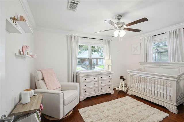 1213 Focis St, Metairie, LA 70005 - bedroom with a crib, dark wood finished floors, crown molding, and ceiling fan