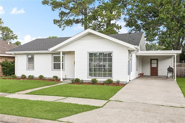 42 Tulip Dr, Gretna, LA 70053 - single story home with concrete driveway, a shingled roof, and an attached carport