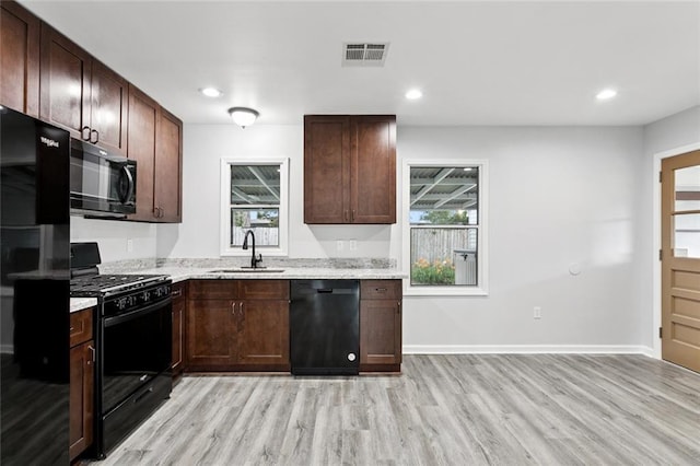 42 Tulip Dr, Gretna, LA 70053 - kitchen with black appliances, light wood finished floors, plenty of natural light, and recessed lighting