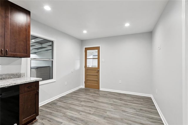 42 Tulip Dr, Gretna, LA 70053 - kitchen with light wood-style flooring, dark brown cabinets, black dishwasher, recessed lighting, and light stone countertops