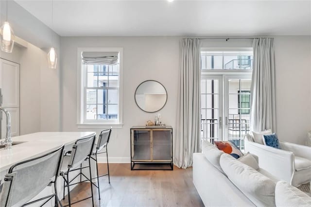731 St Charles Ave Unit 304, New Orleans, LA 70130 - living room featuring light wood-type flooring and baseboards