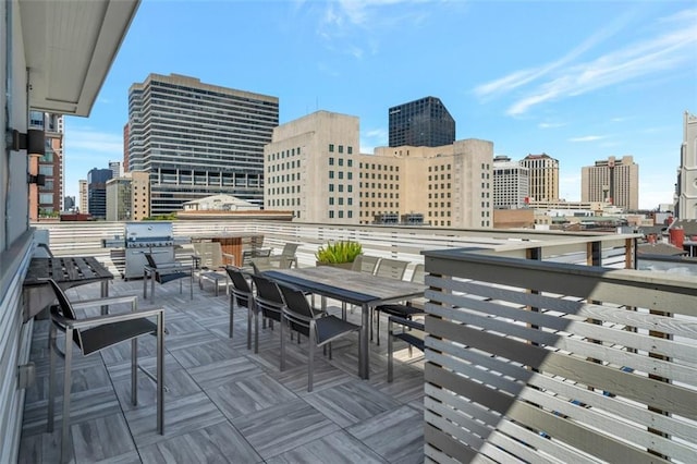 731 St Charles Ave Unit 304, New Orleans, LA 70130 - deck featuring a view of skyline, outdoor dining space, and grilling area