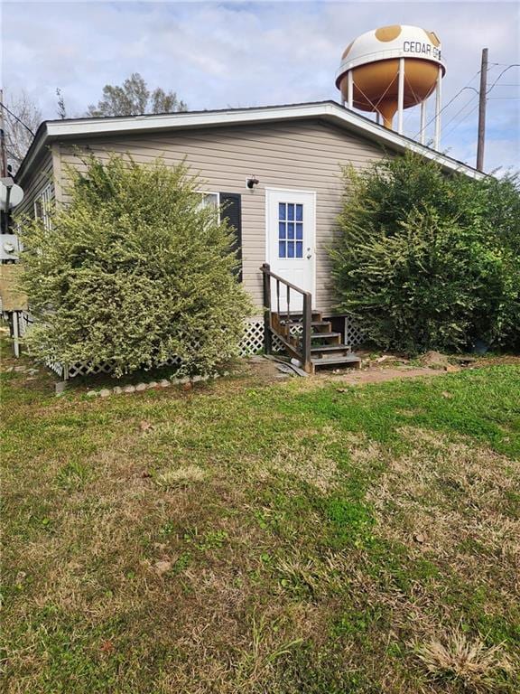 116 Cedar Dr, Belle Chasse, LA 70037 - back of house featuring entry steps and a yard