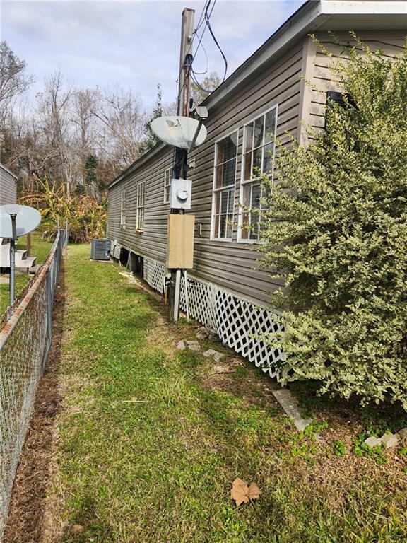 116 Cedar Dr, Belle Chasse, LA 70037 - view of side of property with a central air condition unit