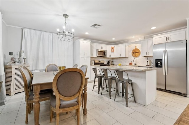 917 Ellen St, Terrytown, LA 70056 - dining room featuring a chandelier, recessed lighting, and light tile patterned floors