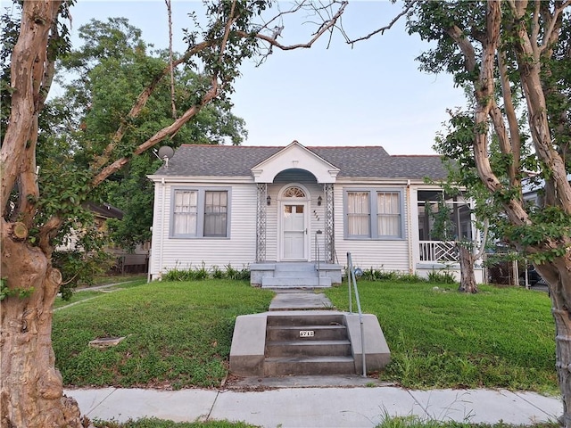 4712 Lafaye St, New Orleans, LA 70122 - view of front of home with a front lawn and a shingled roof