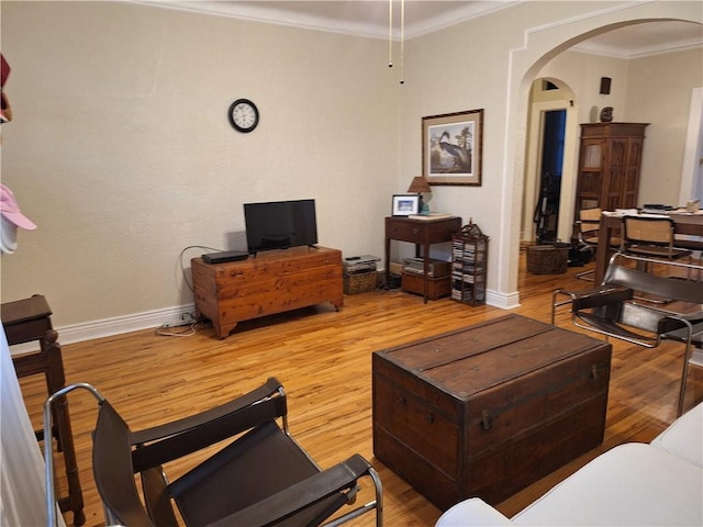 4712 Lafaye St, New Orleans, LA 70122 - living area featuring arched walkways, wood finished floors, and ornamental molding