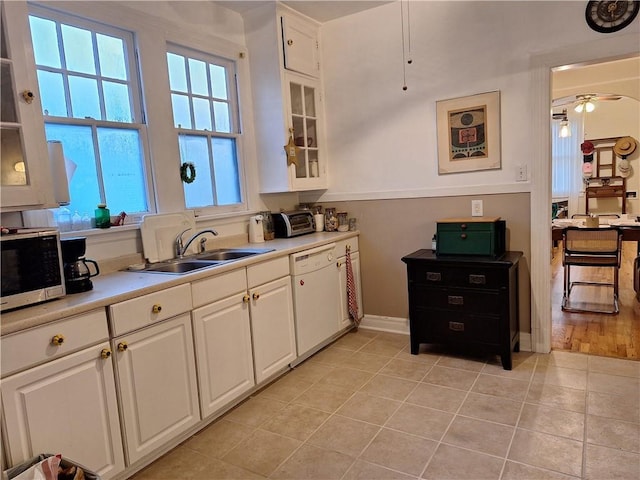 4712 Lafaye St, New Orleans, LA 70122 - kitchen featuring dishwasher, stainless steel microwave, white cabinets, light countertops, and glass insert cabinets
