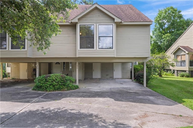 34 Chamale Cv Unit 34, Slidell, LA 70460 - view of property with concrete driveway, a shingled roof, a front yard, and a carport
