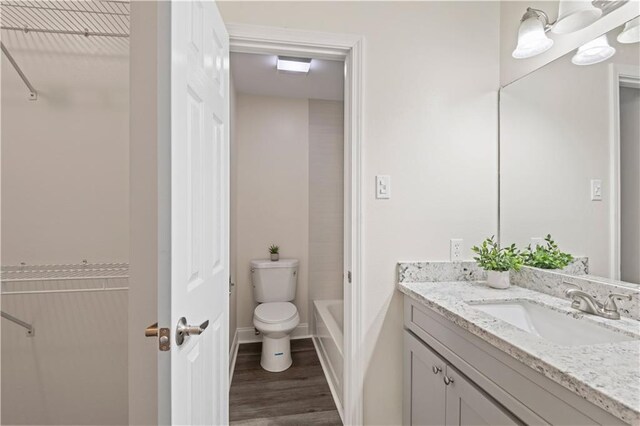 34 Chamale Cv Unit 34, Slidell, LA 70460 - full bath featuring vanity, wood finished floors, and a walk in closet