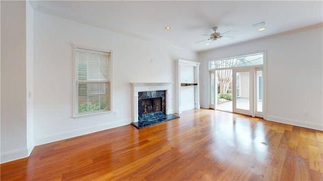 3739 N Hullen St, Metairie, LA 70002 - unfurnished living room featuring a ceiling fan, a premium fireplace, wood finished floors, crown molding, and recessed lighting